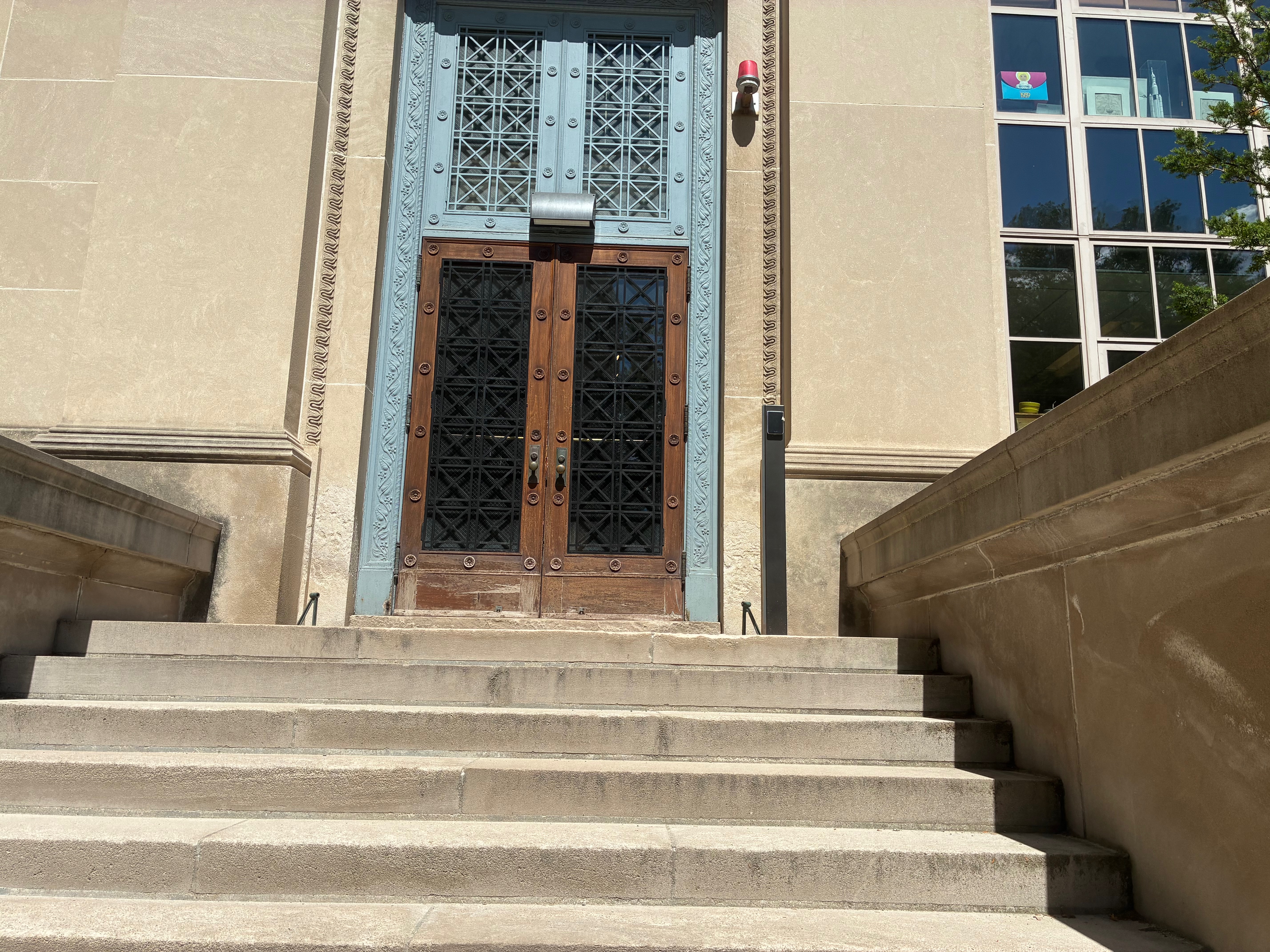 Ornate central entrance doors at the top of the steps