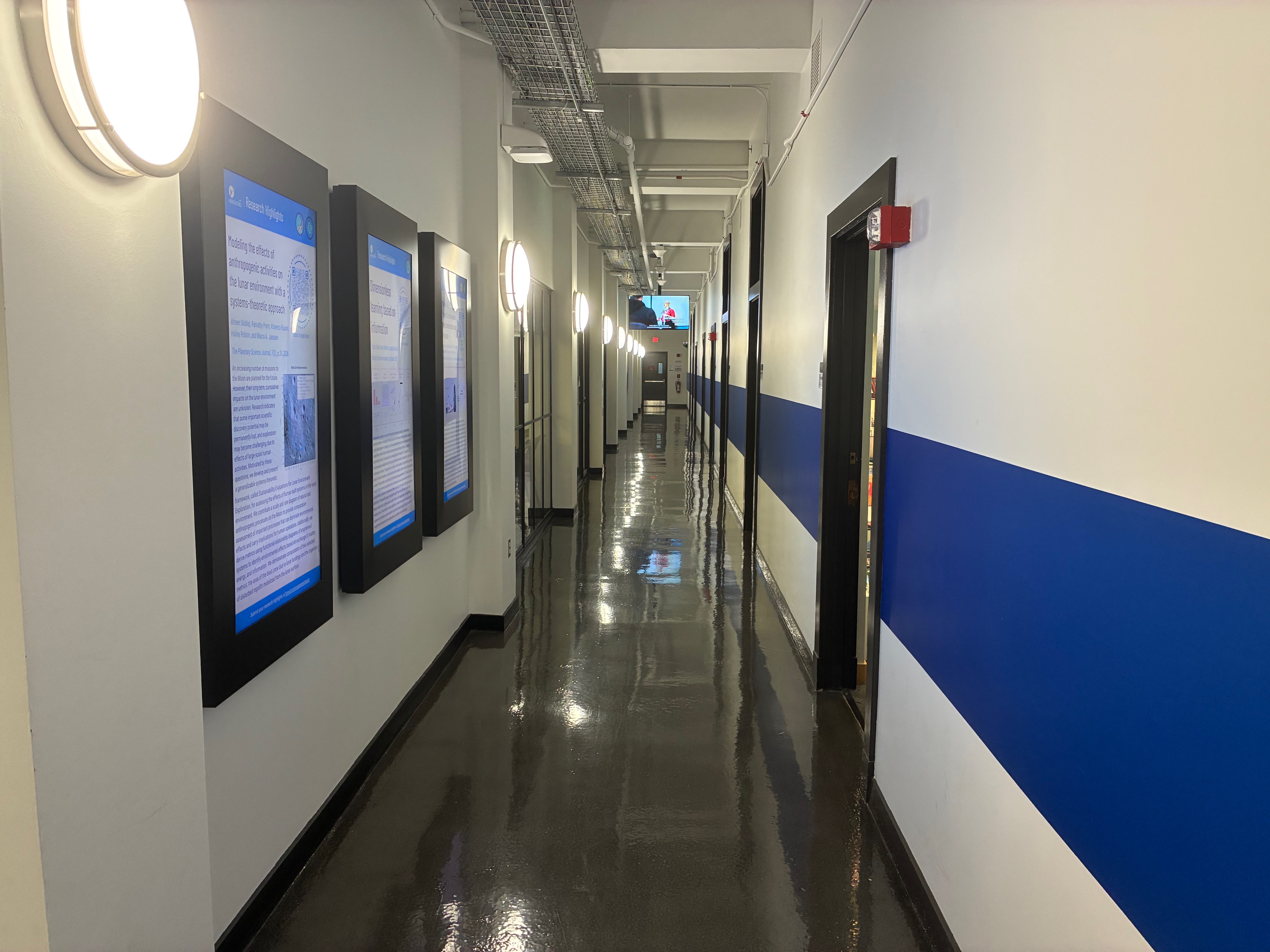 Long hallway with a blue stripe along the wall
